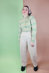 Women's vintage 1960's long sleeve button up cardigan in all wool material. Light green with an all over darker green abstract print.