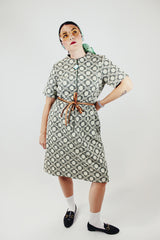 short sleeve green and cream printed knee length dress with front zipper and tie belt vintage 1970's