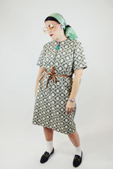 short sleeve green and cream printed knee length dress with front zipper and tie belt vintage 1970's