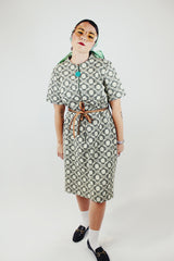 short sleeve green and cream printed knee length dress with front zipper and tie belt vintage 1970's