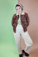 Women's vintage 1970's Ms. Pioneer label long sleeve brown suede short zip up jacket with cream faux fur trim on collar.