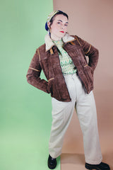 Women's vintage 1970's Ms. Pioneer label long sleeve brown suede short zip up jacket with cream faux fur trim on collar.