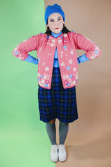 Women's vintage 1950's Gene Shelly's Miss Boutique California label 3/4 arm length open front pink cardigan sweater in wool material with blue, white, and pink embroidered flowers all over