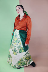 Women's vintage 1970's Chelsea Davis label a line shaped maxi skirt in a patchwork quilted print. Green velvet with white and green floral patches.