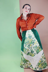 Women's vintage 1970's Chelsea Davis label a line shaped maxi skirt in a patchwork quilted print. Green velvet with white and green floral patches.