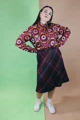 Women's vintage 1990's Take 1 label knee length a-line shaped skirt with elastic waistband in a multicolored plaid print in a polyester acrylic blend material.