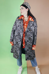 Women's vintage 1960's long sleeve long length brown and white tapestry print coat with a double breasted closure.