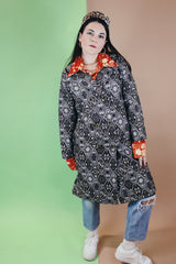 Women's vintage 1960's long sleeve long length brown and white tapestry print coat with a double breasted closure.