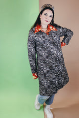 Women's vintage 1960's long sleeve long length brown and white tapestry print coat with a double breasted closure.