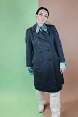 Women's vintage 1960's long sleeve cotton double breasted trench coat in a grey green color.