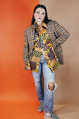 Men's vintage 1970's SKYR label long sleeve button up shirt with a pointy collar in a orange, yellow, and navy patchwork floral print in a lightweight Nylon material.