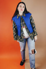 Women's vintage medium 1980's SKYR by Hertha Amen label sleeveless capped sleeved short length zip up bright blue Nylon ski vest with red and green stripes on the sides.