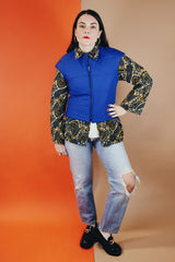 Women's vintage medium 1980's SKYR by Hertha Amen label sleeveless capped sleeved short length zip up bright blue Nylon ski vest with red and green stripes on the sides.