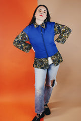 Women's vintage medium 1980's SKYR by Hertha Amen label sleeveless capped sleeved short length zip up bright blue Nylon ski vest with red and green stripes on the sides.