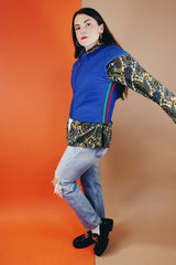 Women's vintage medium 1980's SKYR by Hertha Amen label sleeveless capped sleeved short length zip up bright blue Nylon ski vest with red and green stripes on the sides.