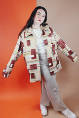 Men's vintage XL 1970's Paul Howard California label long sleeve button up shirt with a pointy collar in a silky soft polyester material with tan, brown, blue, green, and yellow all over abstract print.