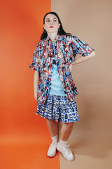 Men's or women's vintage 1970's Joel California label short sleeve button up shirt with a pointy collar. Lightweight polyester material in blue, grey, black, and salmon colored abstract print.