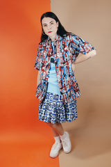 Men's or women's vintage 1970's Joel California label short sleeve button up shirt with a pointy collar. Lightweight polyester material in blue, grey, black, and salmon colored abstract print.