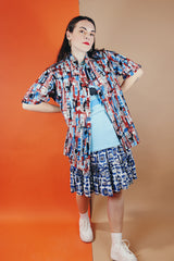 Men's or women's vintage 1970's Joel California label short sleeve button up shirt with a pointy collar. Lightweight polyester material in blue, grey, black, and salmon colored abstract print.