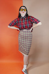 Women's vintage 1970's high waisted midi length pencil skirt in cream with yellow, red, and black plaid print in a wool material
