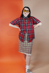 Women's or men's vintage 1970's Golden Award short sleeve plaid print button up shirt with pointy collar. Polyester cotton blend material in a red, black, white, and yellow plaid print.