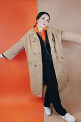 Women's vintage 1960's Dumas label 100% Mongolian camel hair coat in light tan colored with a double breasted closure, double lapel, and two pockets