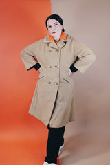 Women's vintage 1960's Dumas label 100% Mongolian camel hair coat in light tan colored with a double breasted closure, double lapel, and two pockets