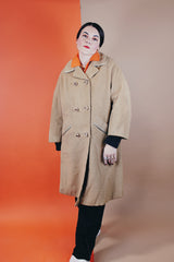 Women's vintage 1960's Dumas label 100% Mongolian camel hair coat in light tan colored with a double breasted closure, double lapel, and two pockets
