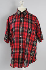 Women's or men's vintage 1970's Golden Award short sleeve plaid print button up shirt with pointy collar. Polyester cotton blend material in a red, black, white, and yellow plaid print.