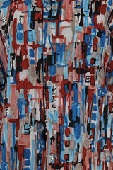 Men's or women's vintage 1970's Joel California label short sleeve button up shirt with a pointy collar. Lightweight polyester material in blue, grey, black, and salmon colored abstract print.