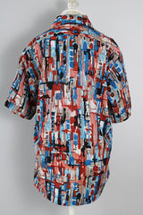 Men's or women's vintage 1970's Joel California label short sleeve button up shirt with a pointy collar. Lightweight polyester material in blue, grey, black, and salmon colored abstract print.
