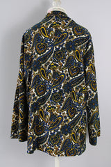 Women's vintage 1970's Hand Fashion long sleeve polyester blouse with a collar and gold buttons. Blue, white, and yellow paisley all over print.