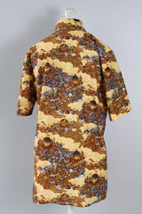 Women's or men's vintage 1970's short sleeve button up shirt with a pointy collar, brown buttons, and all over print in lightweight, soft polyester material
