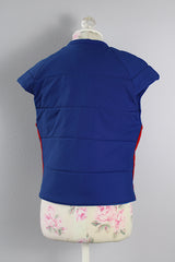 Women's vintage medium 1980's SKYR by Hertha Amen label sleeveless capped sleeved short length zip up bright blue Nylon ski vest with red and green stripes on the sides.