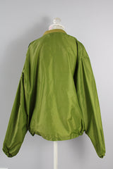 Men's or women's vintage 1960's Puritan Gary Player Sportswear, Made in USA label long sleeve olive green lightweight nylon bomber jacket with a zipper in the front.