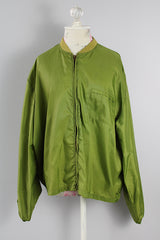 Men's or women's vintage 1960's Puritan Gary Player Sportswear, Made in USA label long sleeve olive green lightweight nylon bomber jacket with a zipper in the front.