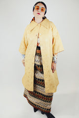 gold colored quilted duster jacket buttons up the front with collar and moon and star all over print