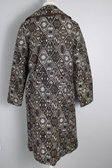 Women's vintage 1960's long sleeve long length brown and white tapestry print coat with a double breasted closure.