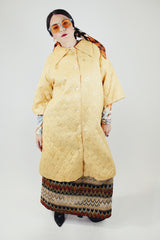 gold colored quilted duster jacket buttons up the front with collar and moon and star all over print