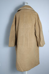 Women's vintage 1960's Dumas label 100% Mongolian camel hair coat in light tan colored with a double breasted closure, double lapel, and two pockets