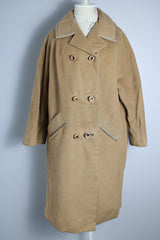 Women's vintage 1960's Dumas label 100% Mongolian camel hair coat in light tan colored with a double breasted closure, double lapel, and two pockets