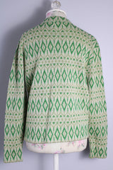Women's vintage 1960's long sleeve button up cardigan in all wool material. Light green with an all over darker green abstract print.