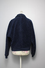 Women's vintage 1970's Woolrich Woman, Made in USA label long sleeve navy fleece sweater. Popper buttons up the front, two pockets, rolled collar, and white speckle print all over.