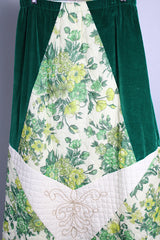 Women's vintage 1970's Chelsea Davis label a line shaped maxi skirt in a patchwork quilted print. Green velvet with white and green floral patches.