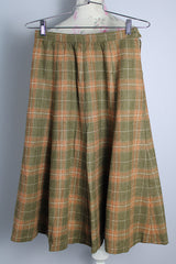 Women's vintage 1970's wool material plaid printed pleated knee length high waisted skirt. Olive green with tan, cream, and burnt orange plaid