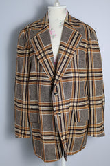 Men's vintage 1960's The Squire Shop long sleeve wool plaid print blazer with a two button closure and double lapel. Plaid print is various shades of brown.