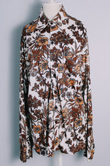 Men's vintage 1970's long sleeve button up shirt with a pointy collar in a lightweight Polyester material. White with all over brown floral print.