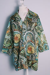 Women's or men's vintage 1970's Montgomery Ward label short sleeves on the long side, button up shirt with pointy collar in an all over abstract print in greens and yellows.