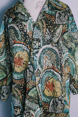 Women's or men's vintage 1970's Montgomery Ward label short sleeves on the long side, button up shirt with pointy collar in an all over abstract print in greens and yellows.