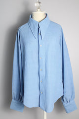Men's or women's vintage 1970's long sleeve light blue polyester button up shirt with very pointy dagger collar and puff sleeves.
